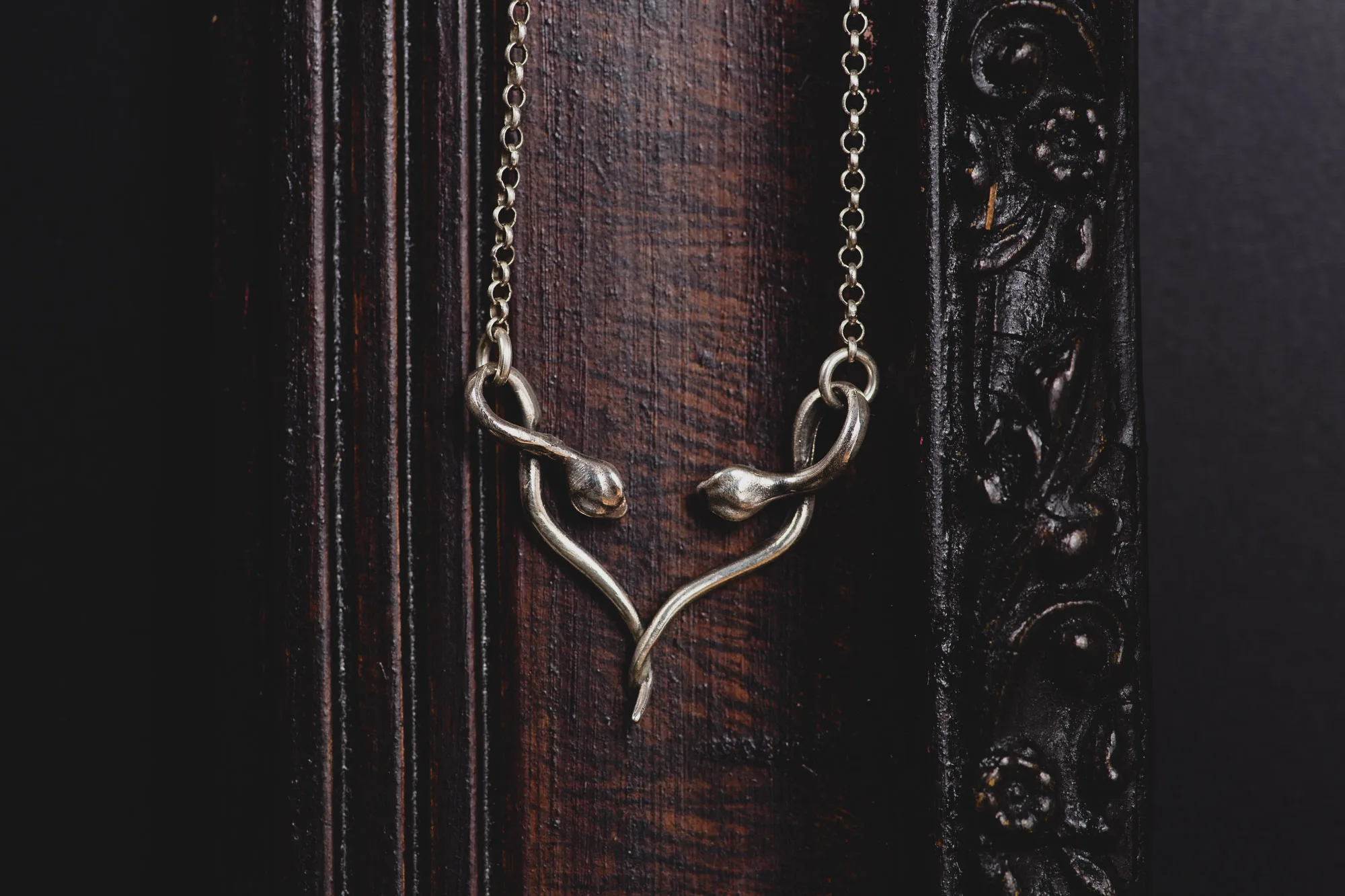 An image of a Double Snake Sterling Silver Pendant, handcrafted in Greece by Marren Jewelry studio.