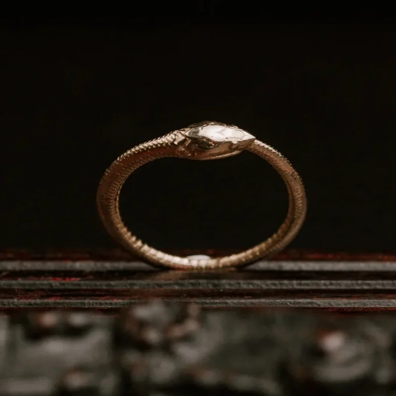 An image of an Ouroboros 14K Gold Ring, handcrafted by Marren Jewelry in Greece.