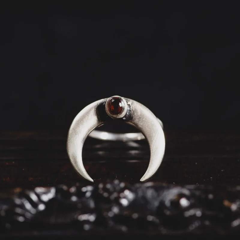 An image showing a Garnet Moon Horn Sterling Silver Ring, handcrafted by Marren Jewelry studio in Greece.