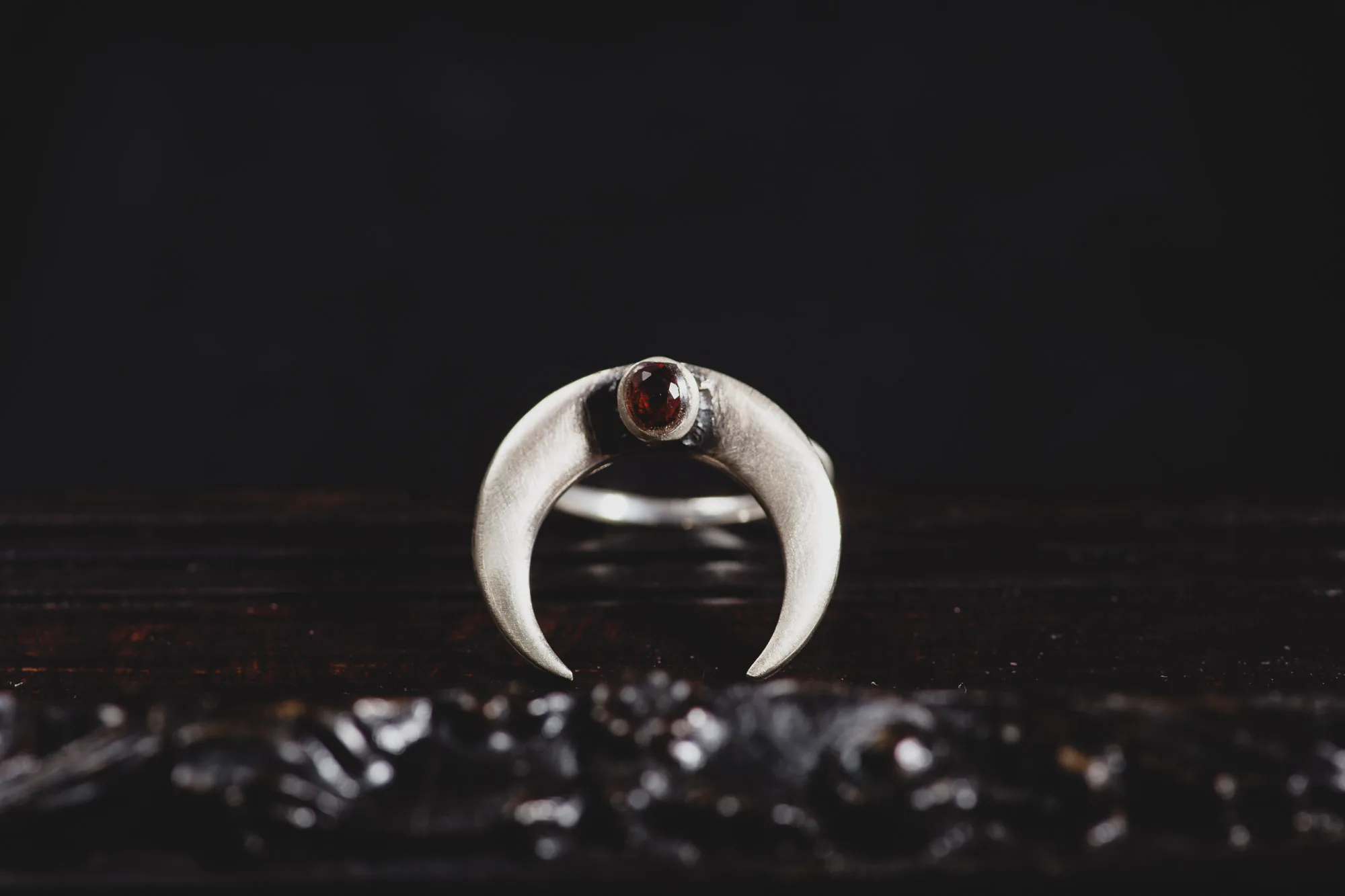 An image showing a Garnet Moon Horn Sterling Silver Ring, handcrafted by Marren Jewelry studio in Greece.