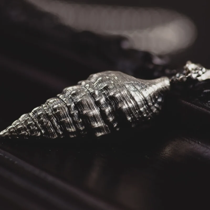 An image of a long Seashell Sterling Silver Pendant, handmade in Greece by Marren Jewelry.
