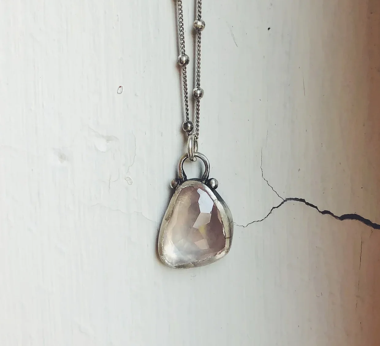 An image of a Rose Quartz Sterling Silver Pendant, handcrafted by Marren Jewelry studio in Greece