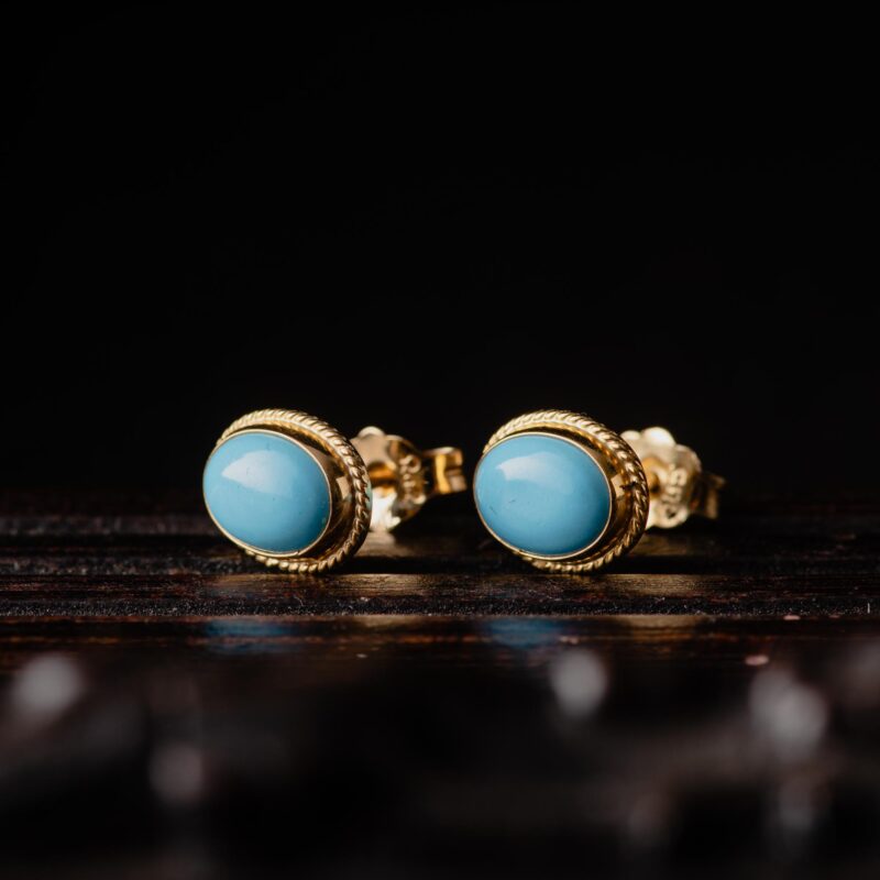 A pair of 14K yellow gold turquoise stud earrings
