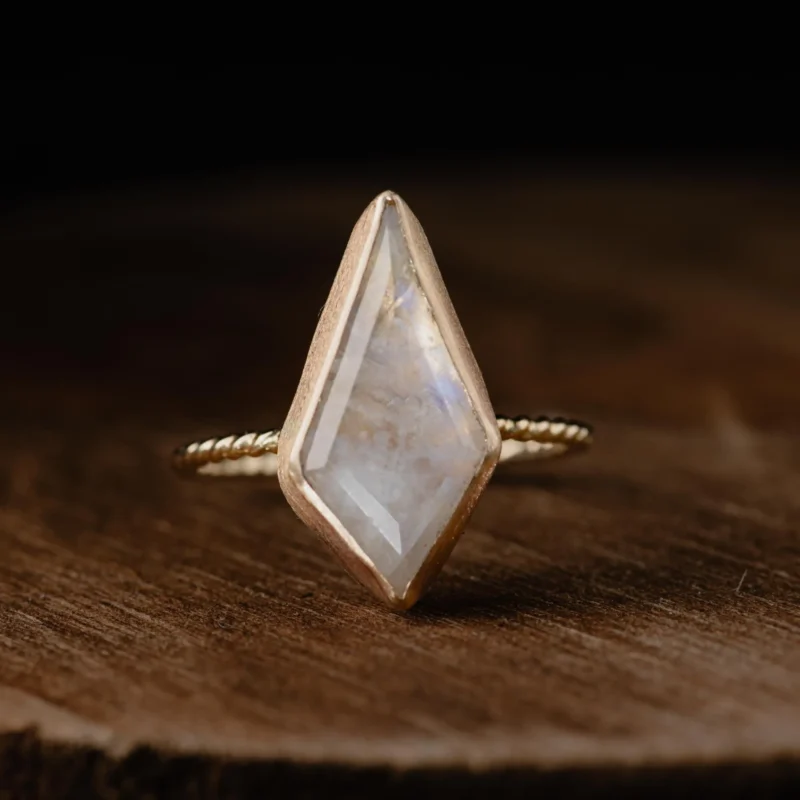 A 14K gold kite shaped moonstone ring with twisted band