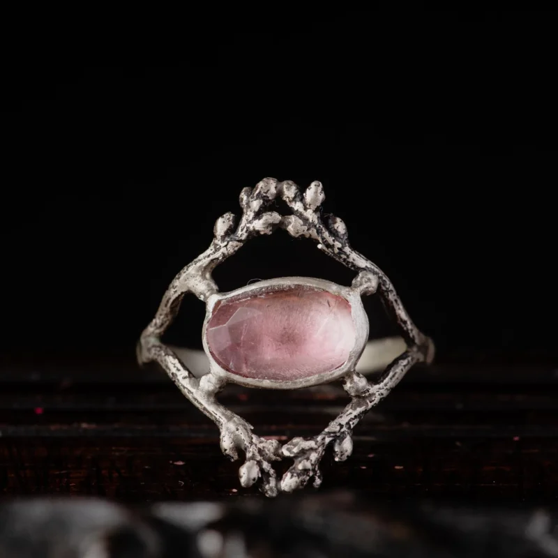 An image showing a glowy pink tourmaline twig ring
