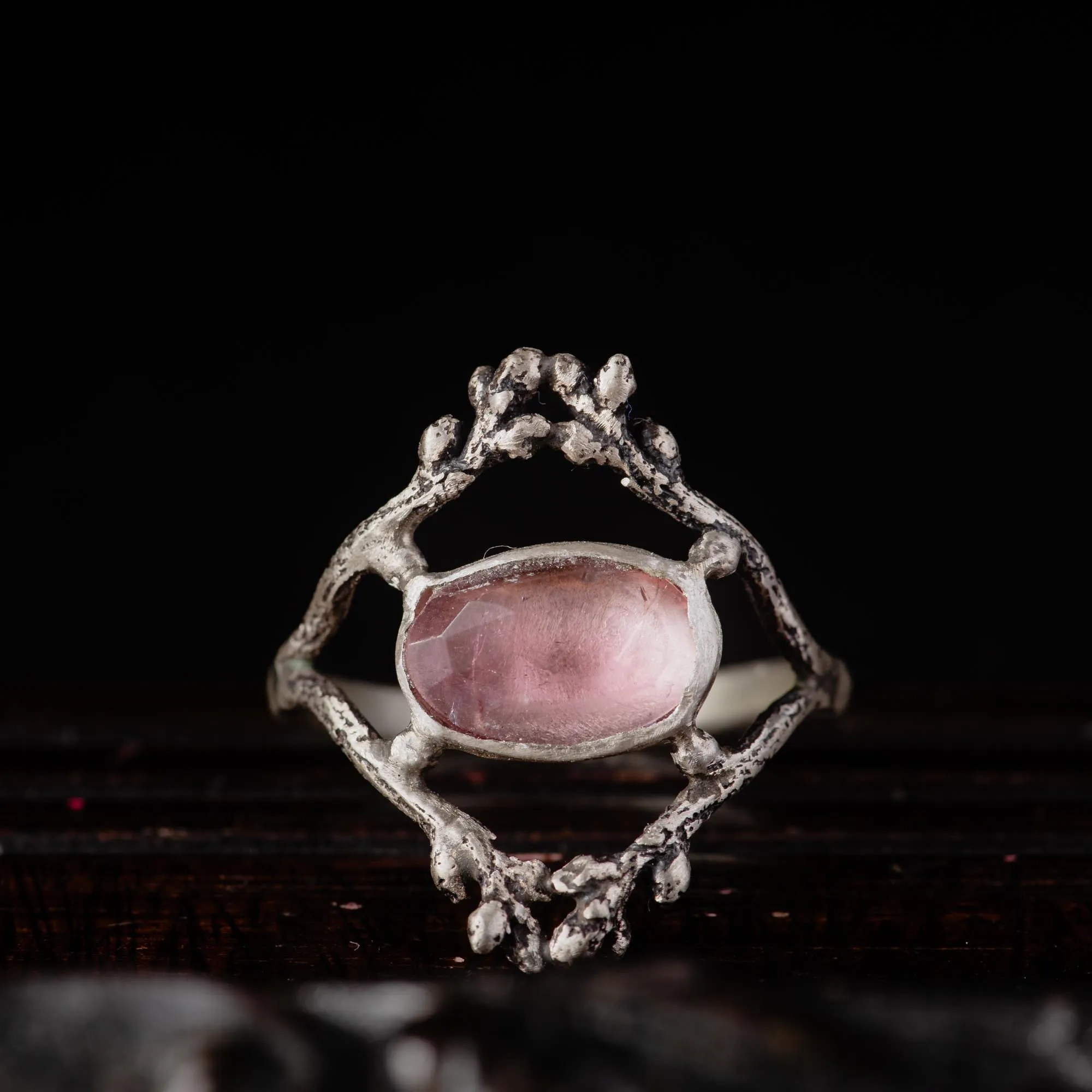 An image showing a glowy pink tourmaline twig ring