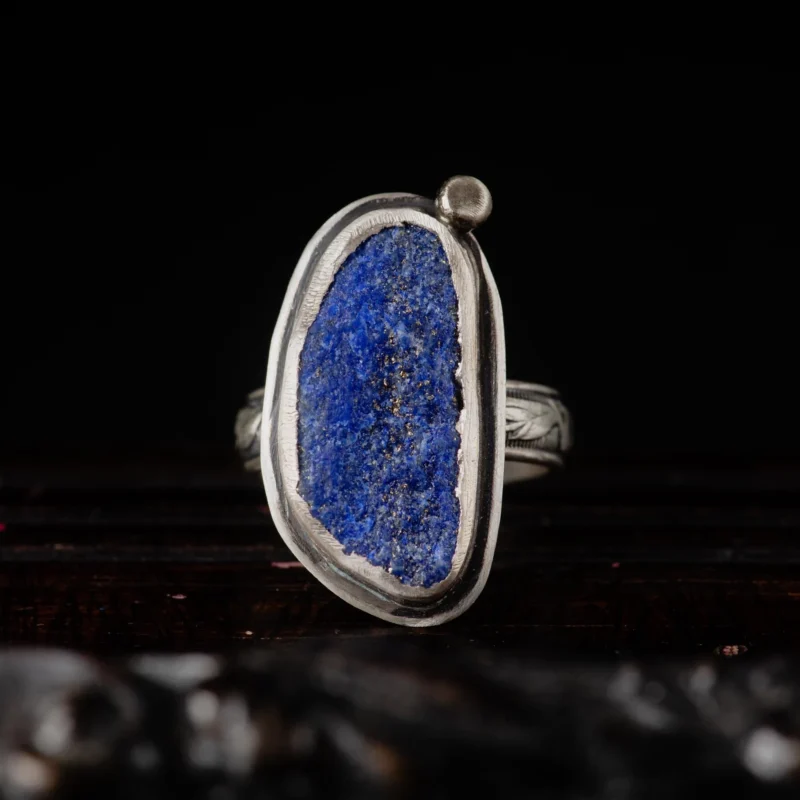 An image showing a raw blue azurite sterling silver ring with floral band