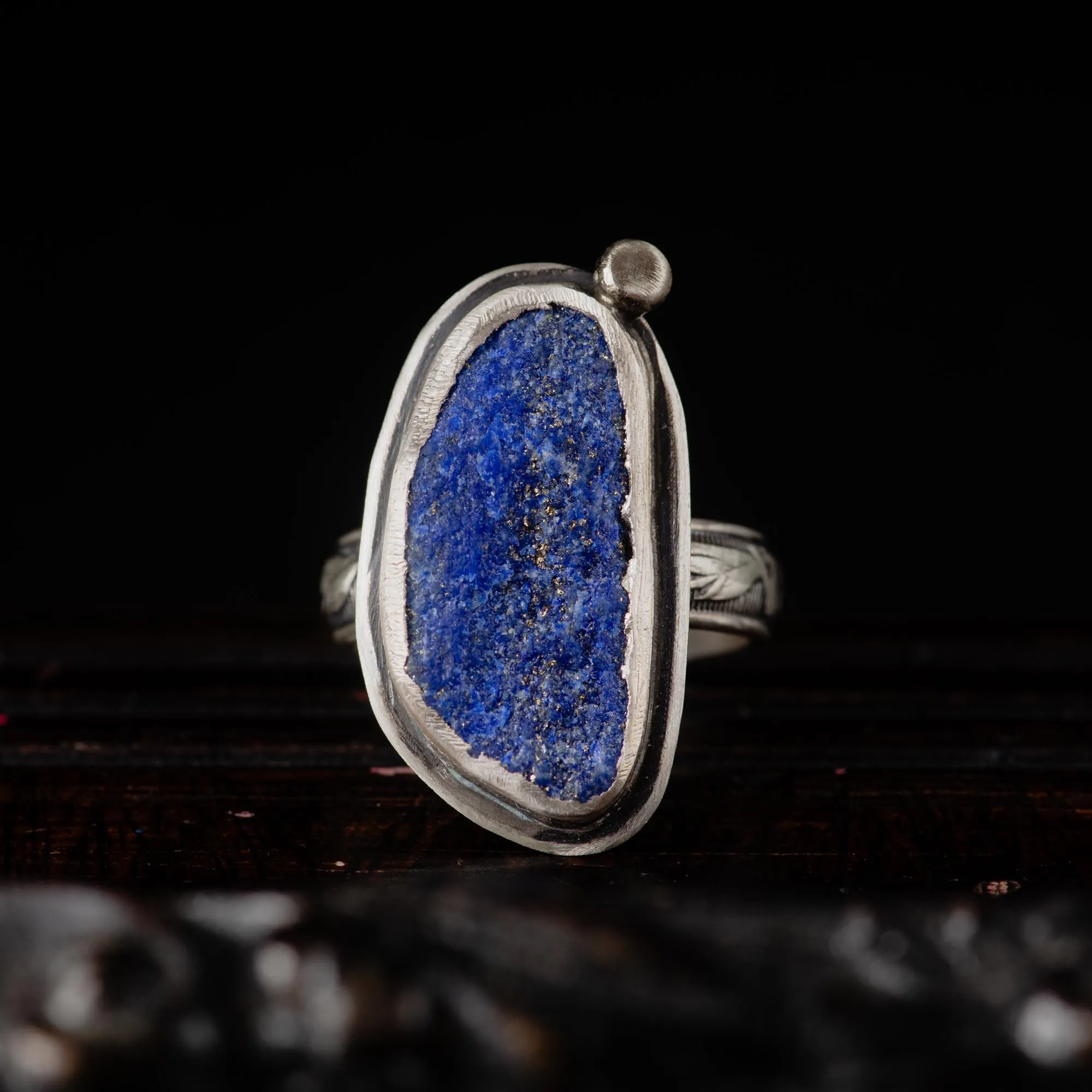 An image showing a raw blue azurite sterling silver ring with floral band