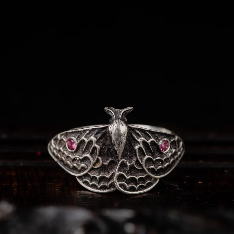 An image showing a sterling silver moth ring with two pink tourmalines