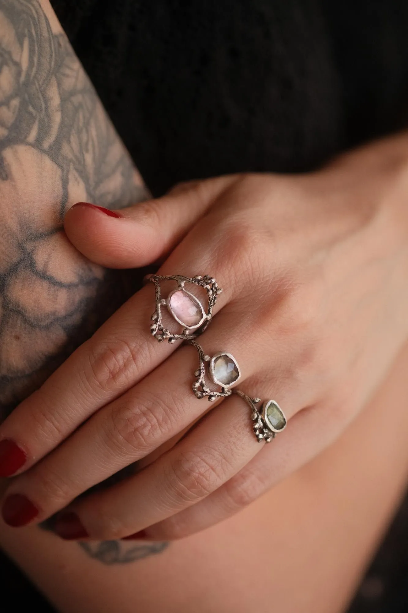 An image showing 3 tourmaline twig rings on a finger