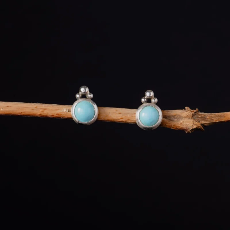 An image showing brigh blue cloud mountain turquoise earrings with bead details