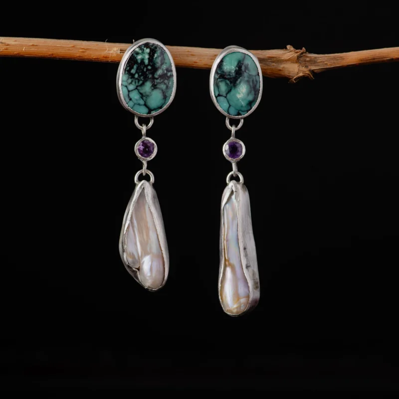 An image showing sterling silver earrings featuring turquoise, amethysts, baroque pearls